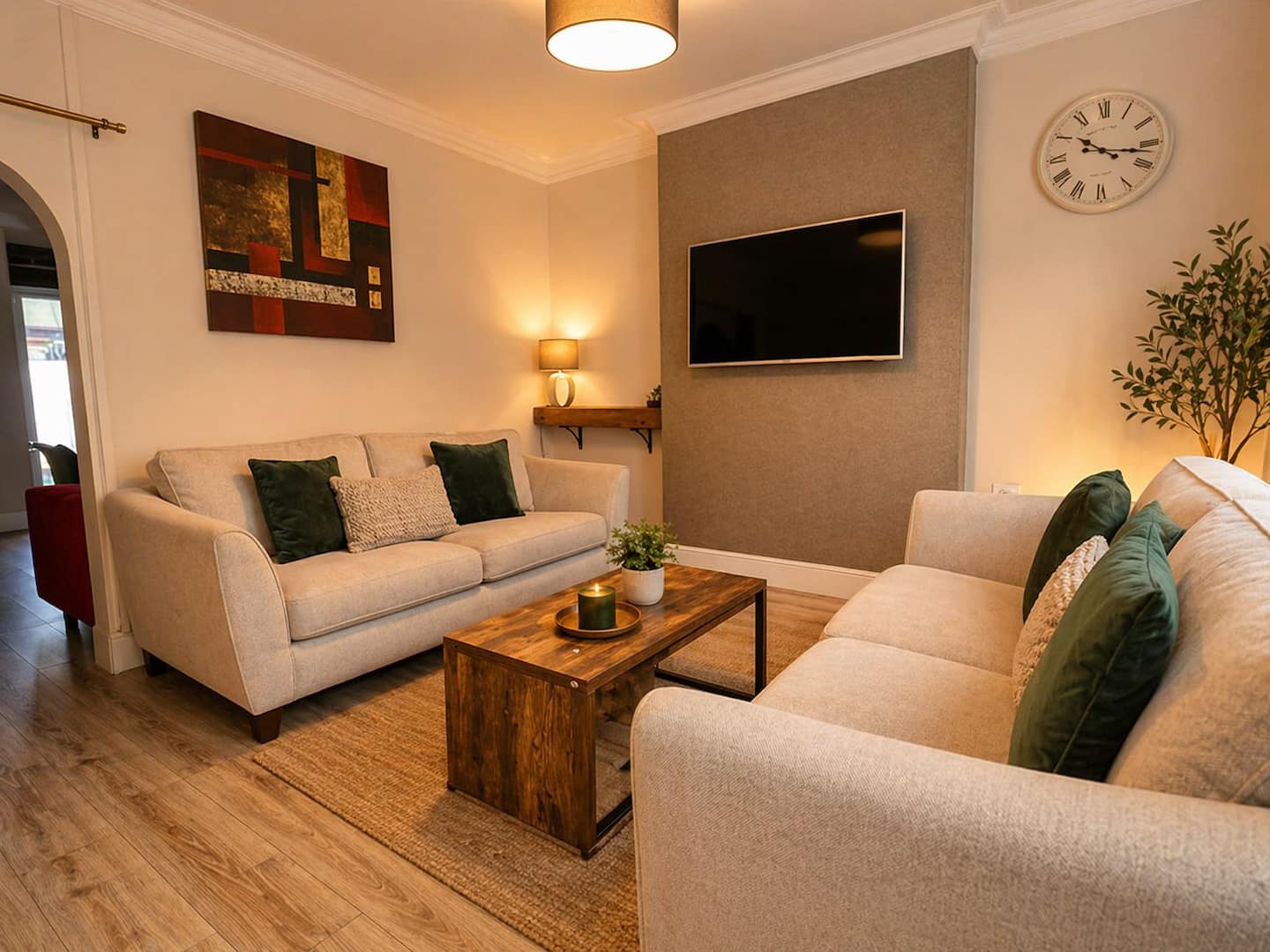 3-Bed Garden Apartment sitting room 3-Bed Garden Apartment sitting room with two sofas and wall-mounted TV, Llandudno